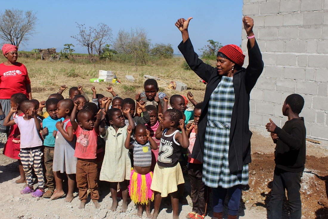 Teacher singing with orphan children