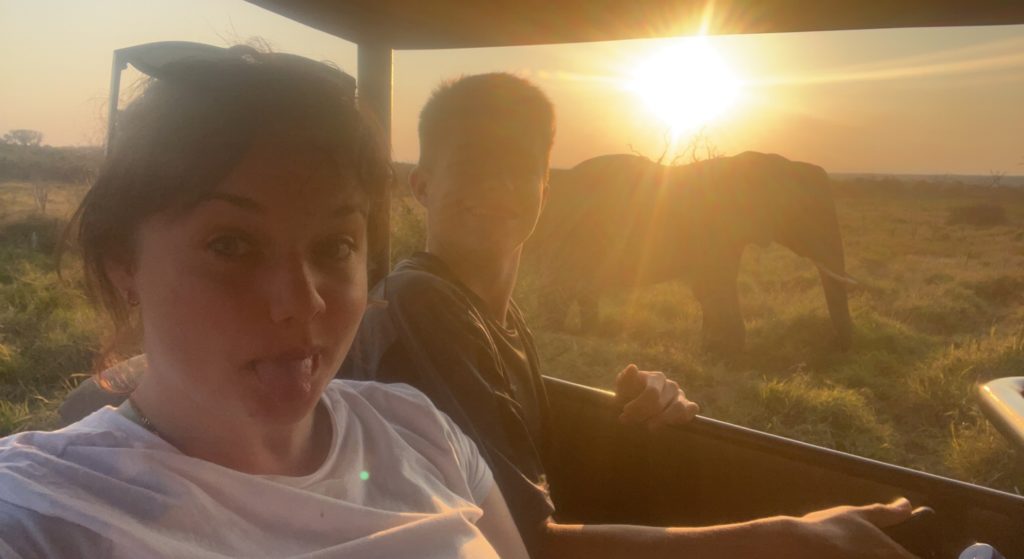 The students on a game drive at sunset